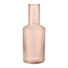 Blush pink glass vase with vertical ribbed patterns, perfect for adding a touch of elegance to any decor.