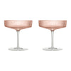 Rose gold champagne coupes with a delicate ribbed pattern and clear glass stems. Perfect for elegant celebrations.