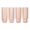 Set of four ribbed blush pink glass vases with a sleek, modern design and a soft, translucent finish.