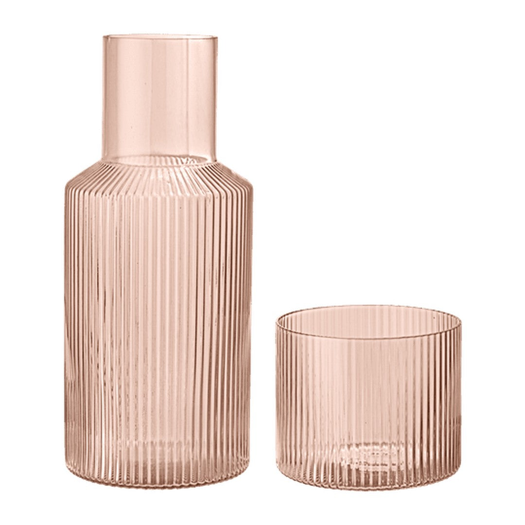 Pair of ribbed glassware in soft pink, featuring a tall carafe and round tumbler, ideal for stylish dining.