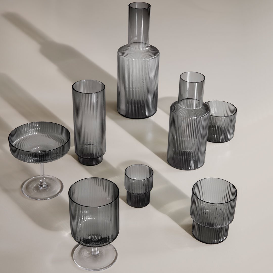 Set of gray and transparent glassware featuring smooth and textured patterns for a modern aesthetic.