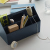 Navy blue organizer with assorted stationery, featuring vibrant patterns in green, white, and natural wood tones.